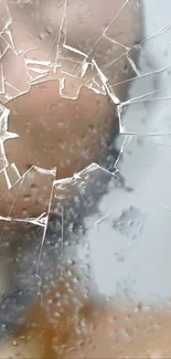 A close-up of shattered glass with raindrops on a mobile wallpaper.