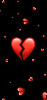 Red broken heart on black wallpaper background.