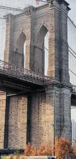 Brooklyn Bridge under clear sky with city view.