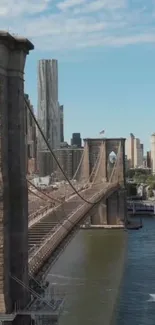 Brooklyn Bridge under blue sky with cityscape in background.