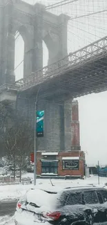 Snowy Brooklyn Bridge scene with car and winter landscape.