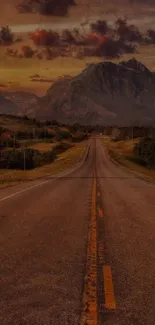 Sunset view of a highway leading into mountains.