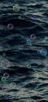 Colorful bubbles float over dark ocean waves in this serene wallpaper.