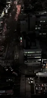 A bustling cityscape at night with illuminated streets and buildings.