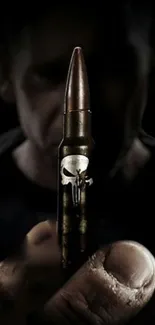 Close-up of a bullet with a skull design in a dark themed wallpaper.