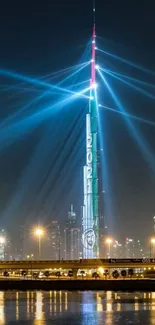 Burj Khalifa illuminated with blue beams at night, reflecting in a calm river.