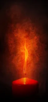 Candle with glowing flame against a dark, smoky background.