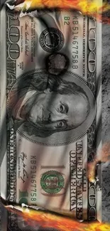 Burning hundred dollar bill with smoke and flames.