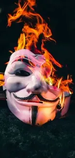 Mobile wallpaper featuring a mask engulfed in flames against a dark background.