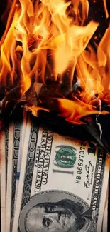 Burning dollar bills with flames on a dark background.