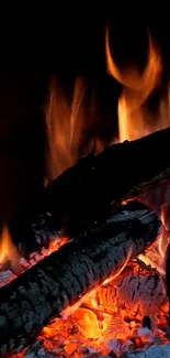 Mobile wallpaper showing burning wood and orange flames.