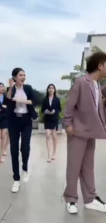 People in business attire dancing on a rooftop.