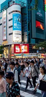 Crowded city street with many pedestrians crossing at dusk.