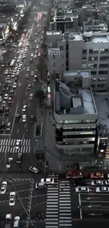 Aerial view of a bustling city street bustling with cars at dusk.