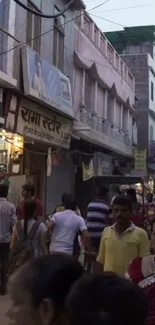 Vibrant urban street scene with people and shops at dusk.