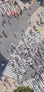 Aerial shot of crowded city crosswalk with people.