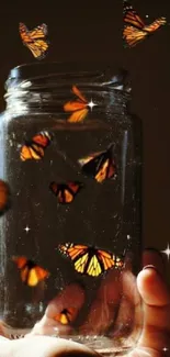 Butterflies in a jar, orange monarchs with brown background.