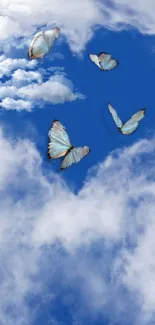 Butterflies soar through a bright blue sky with fluffy white clouds.