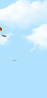 Orange butterflies flying in clear blue sky wallpaper.