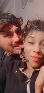 Couple selfie with butterfly filter effects, adding a playful touch.