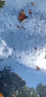 Monarch butterflies migrating in a blue sky over a green forest landscape.