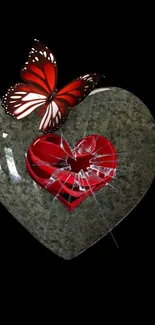 A red butterfly sits on a broken heart against a dark backdrop.