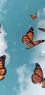 Orange butterflies soar in a bright blue sky with fluffy clouds.