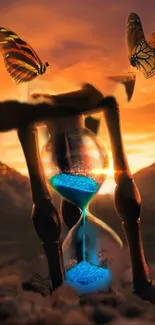 Hourglass with blue sand and butterflies at sunset.