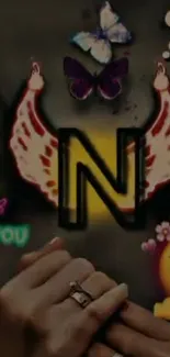 Letter N with butterfly wings and emojis on a colorful background.