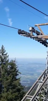 Scenic view from a cable car station with blue skies and trees.