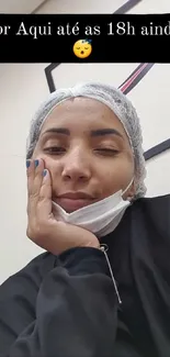 Hospital staff member winking while wearing a hairnet and mask.