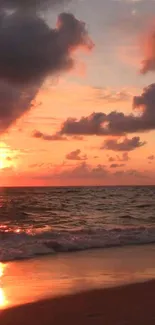 Orange and pink sunset beach scene with waves.