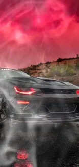 Sleek black Camaro against vibrant red sky.