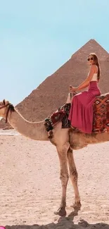 Woman riding camel by pyramids in Egypt.