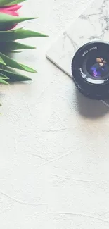 Mobile wallpaper with camera lens and tulips on marble.