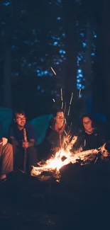 Friends enjoying a campfire under a dark blue sky, capturing a cozy night scene.