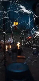 A lantern illuminates a night camping scene with cracked glass effect.