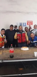 Group celebrating in an industrial workshop.