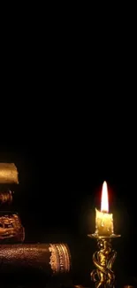 Candlelight illuminating a stack of vintage books on a dark background.