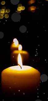 A glowing candle with bokeh lights in a dark background.