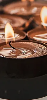 Close-up of a row of softly flickering candles.