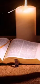 Open book with candlelight on a cozy textile.