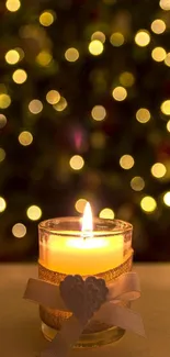 Lit candle with bokeh Christmas lights in background.