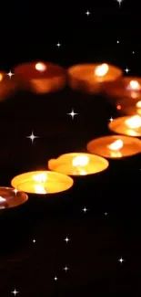 Mobile wallpaper with glowing candles in the dark night.