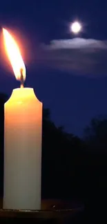 Glowing candle under moonlit night sky wallpaper.