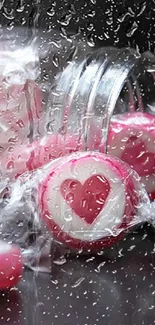 Pink candy hearts in a glass jar with a black background.