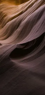 Sandstone formations with flowing textures and warm purple hues.