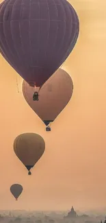 Cappadocia hot air balloons at sunrise over ancient landscape.