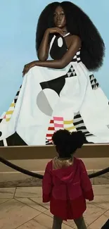 Child admiring a stylish artwork in a museum setting.