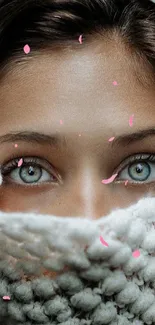 Close-up of eyes with a white knitted scarf.